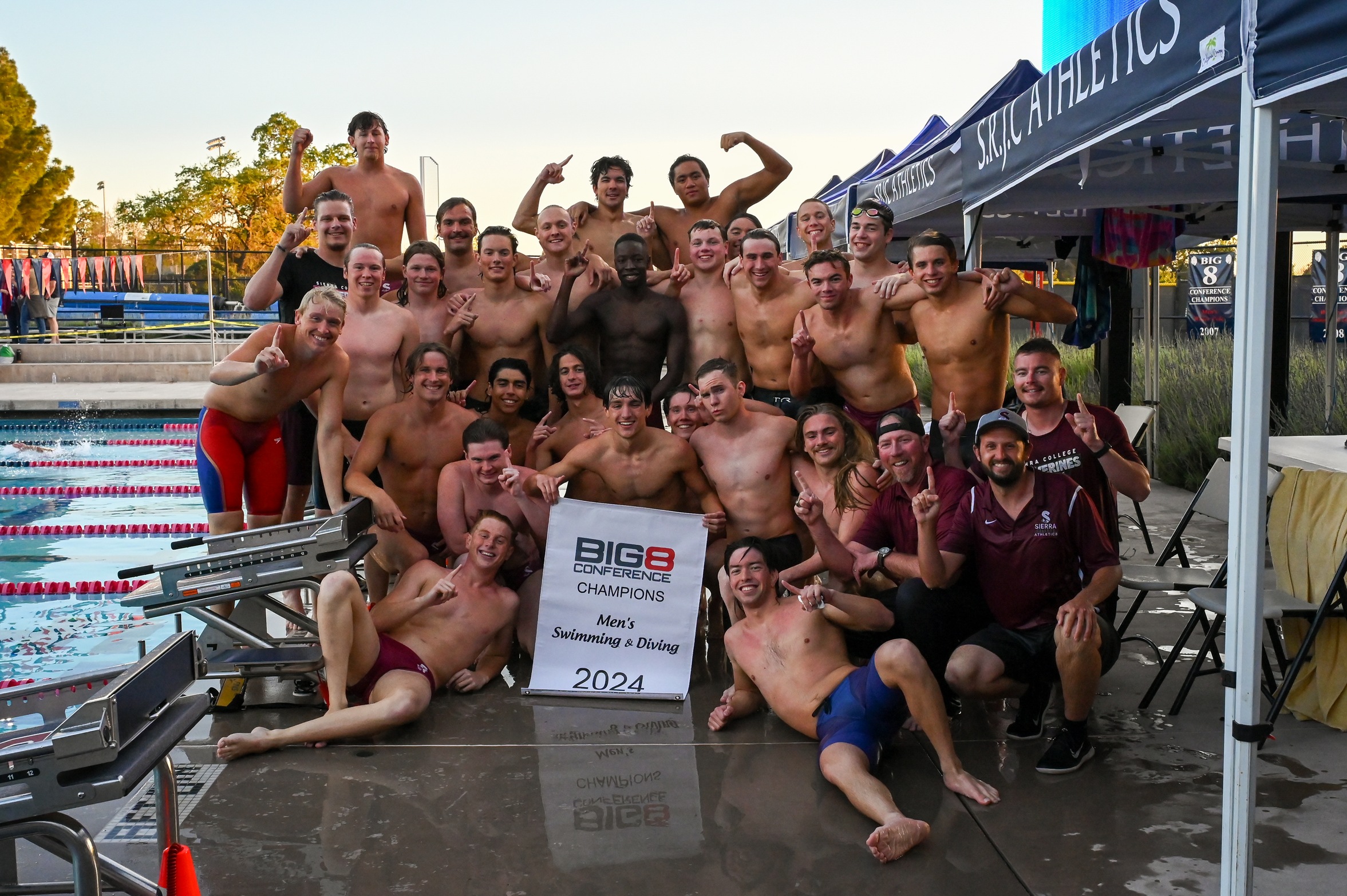 Sierra men's swim and dive Big 8 champs posing for picture.