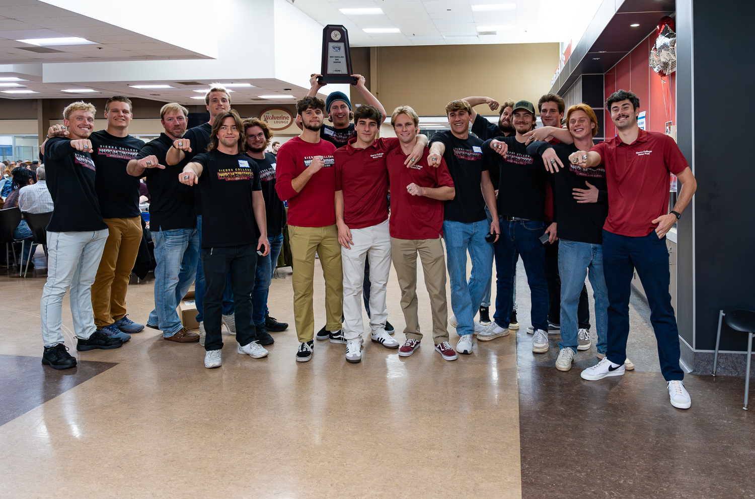 Men's Swim and Dive group shot with state champ rings and trophy.