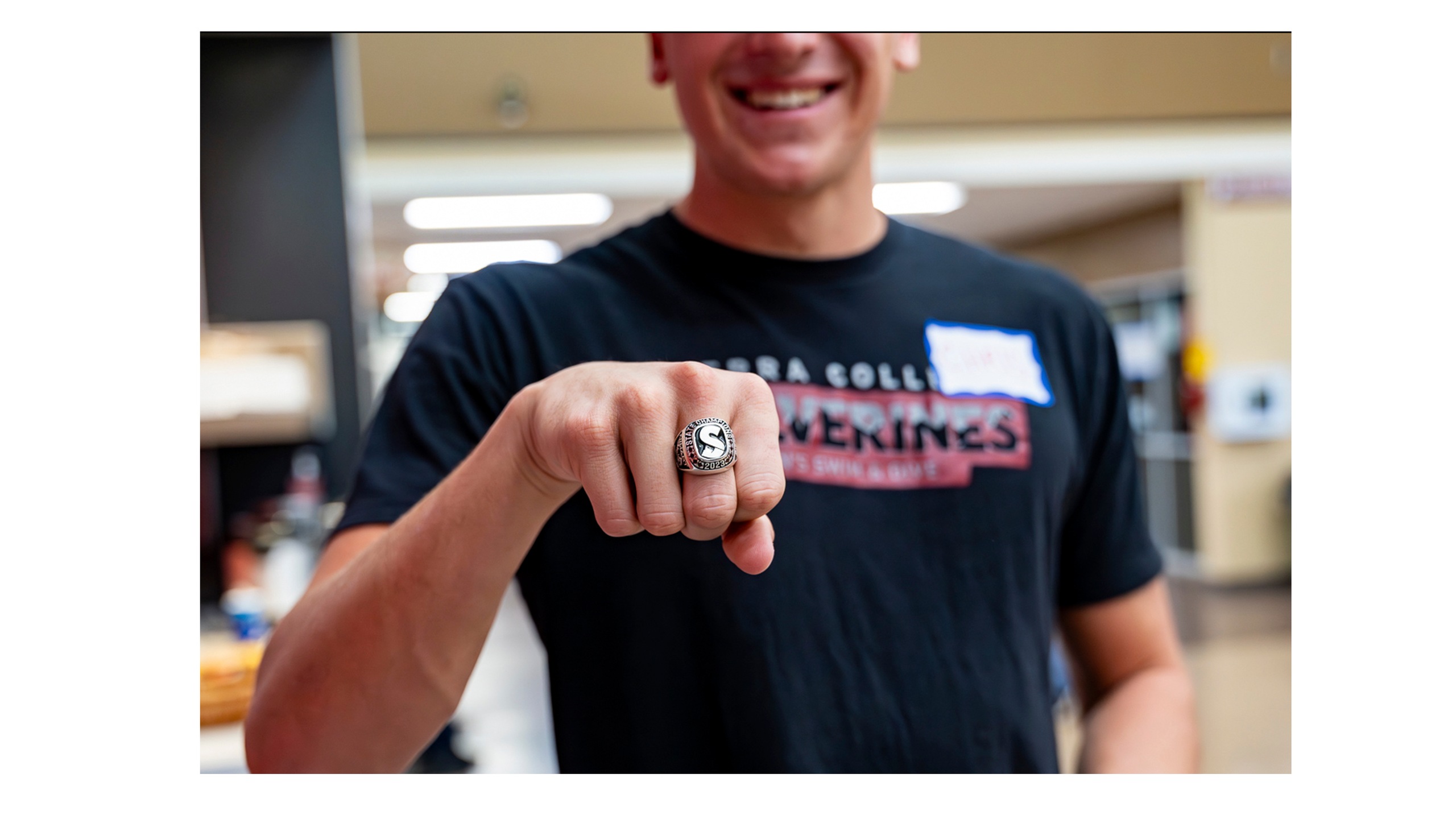 Swimmer holding fist out with Championship ring